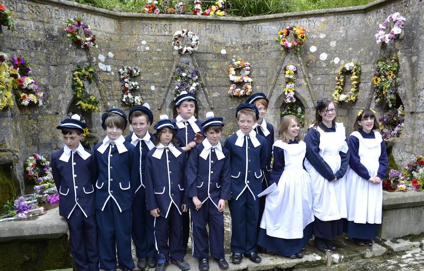 Children from Bisley Blue Coat School dressed in Victorian uniform for the well dressing ceremony, which takes place each year on Ascension Day.